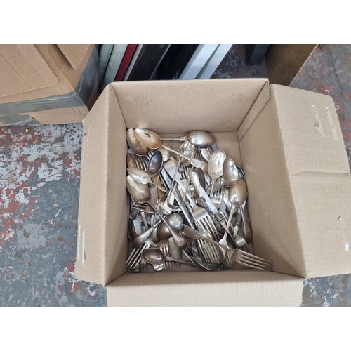 986 - Four boxes containing house clearance items to include table lamps, silver plated cutlery, ceramics,... 