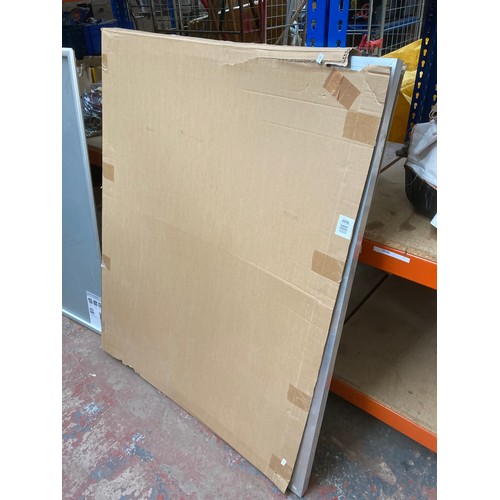 836 - Two wall mountable security frames - largest approx. 130cm high x 94.5cm wide