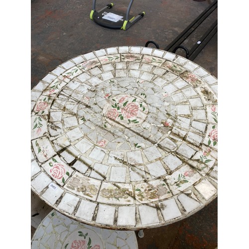 900 - A white painted metal and mosaic three piece patio set comprising circular table and two folding cha... 