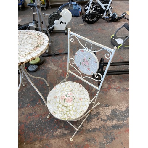 900 - A white painted metal and mosaic three piece patio set comprising circular table and two folding cha... 