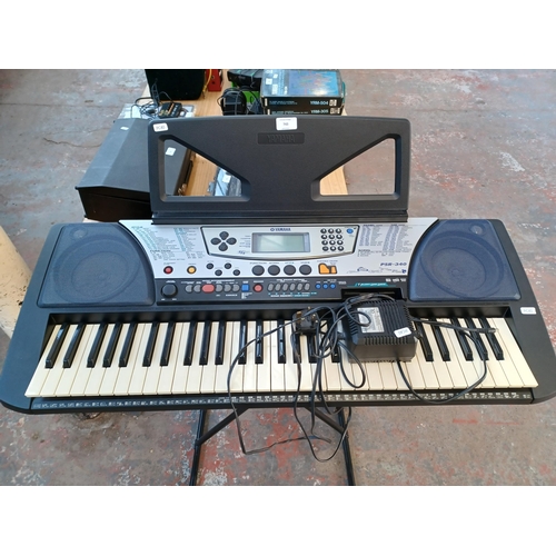 743 - A Yamaha PSR-340 home electronic keyboard with power adaptor and stand