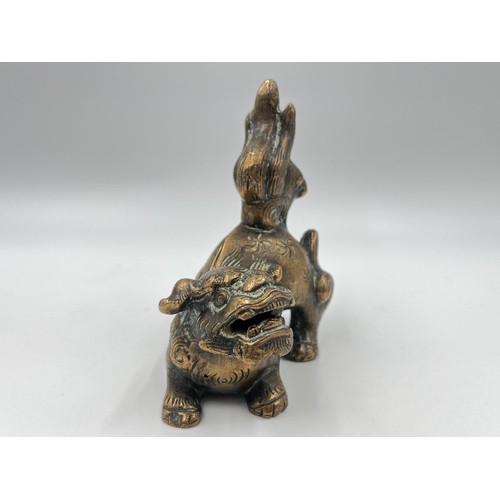 1339 - A Chinese copper fu dog figurine/incense holder - approx. 12cm high