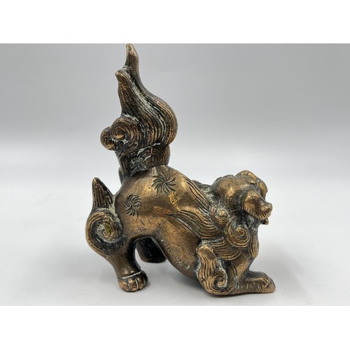 1339 - A Chinese copper fu dog figurine/incense holder - approx. 12cm high