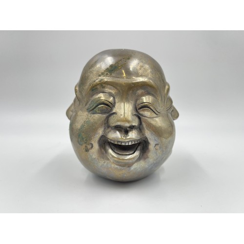 1341 - An Oriental brass four moods buddha head with Pseudo seal mark to base - approx. 11cm high