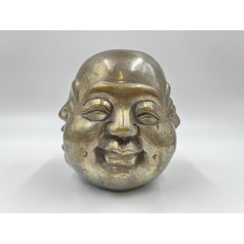 1341 - An Oriental brass four moods buddha head with Pseudo seal mark to base - approx. 11cm high