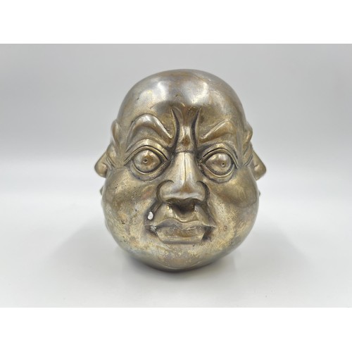 1341 - An Oriental brass four moods buddha head with Pseudo seal mark to base - approx. 11cm high