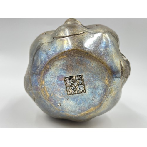 1341 - An Oriental brass four moods buddha head with Pseudo seal mark to base - approx. 11cm high