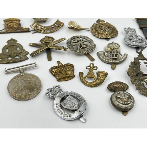 1356 - A collection of militaria and medals to include WWI 1914-1919 Victory medal presented to 200419 PTE.... 