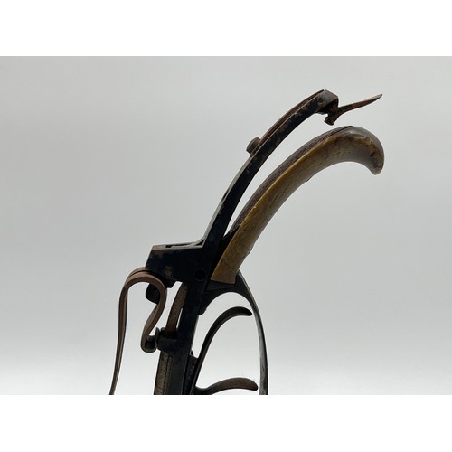 1366 - A 19th century flintlock pistol frame on wooden stand - approx. 21cm high