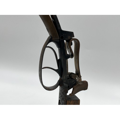 1366 - A 19th century flintlock pistol frame on wooden stand - approx. 21cm high