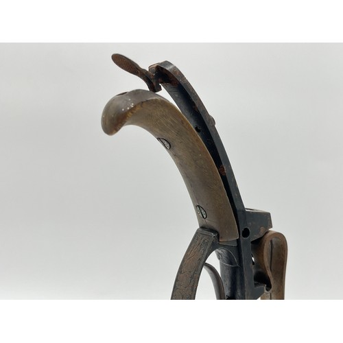 1366 - A 19th century flintlock pistol frame on wooden stand - approx. 21cm high