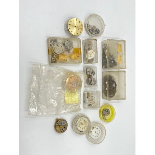 1253B - A large collection of watch parts and watchmakers accessories to include dials, movements, tools, Ro... 