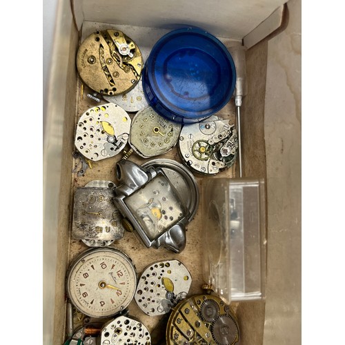 1253B - A large collection of watch parts and watchmakers accessories to include dials, movements, tools, Ro... 