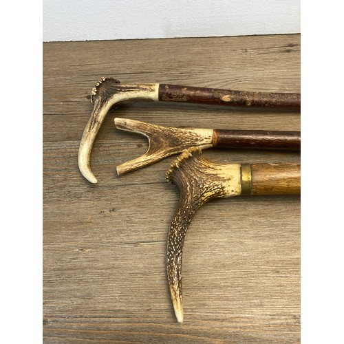 570 - Nine vintage antler handled walking sticks