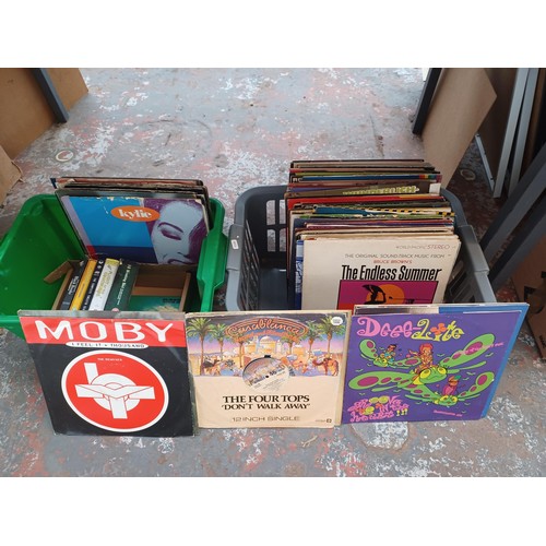 761 - Two boxes containing vinyl records and DVDs to include Buddy Holly, Simon and Garfunkel, Phil Collin... 