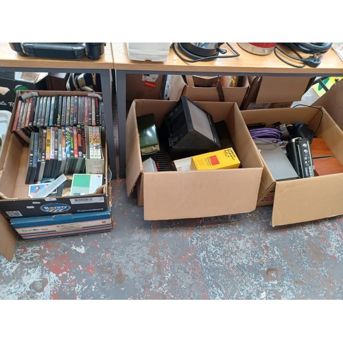 767 - Four boxes containing a collection of items to include vintage laptops, Sanyo cassette radio, speake... 