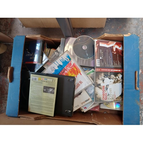 767 - Four boxes containing a collection of items to include vintage laptops, Sanyo cassette radio, speake... 