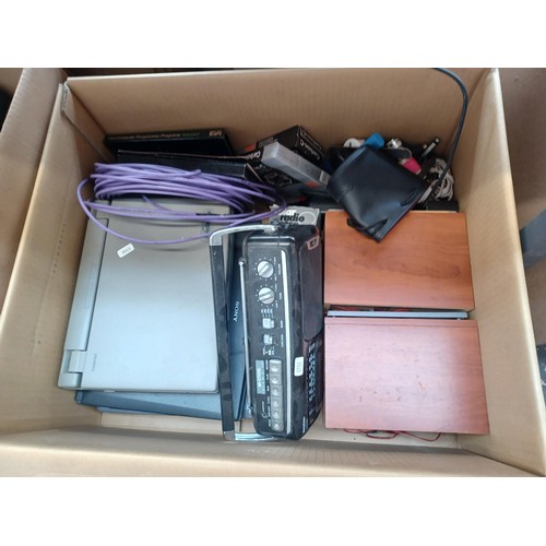 767 - Four boxes containing a collection of items to include vintage laptops, Sanyo cassette radio, speake... 