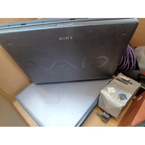 767 - Four boxes containing a collection of items to include vintage laptops, Sanyo cassette radio, speake... 