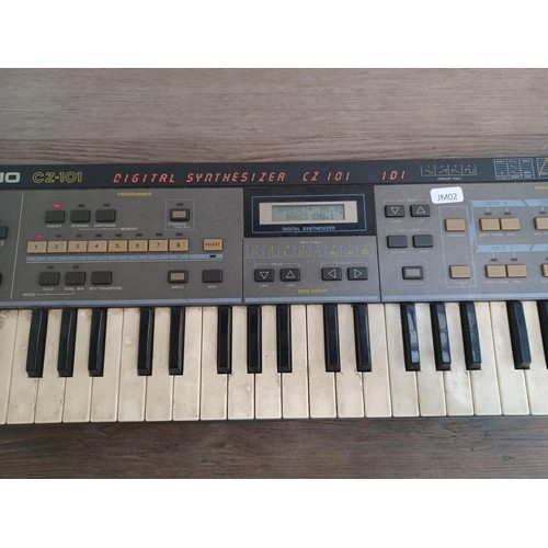 744 - A Casio CZ-101 digital synthesizer with power adapter