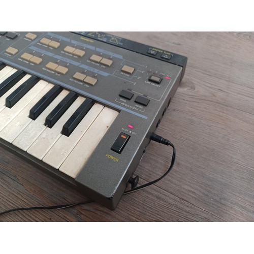 744 - A Casio CZ-101 digital synthesizer with power adapter