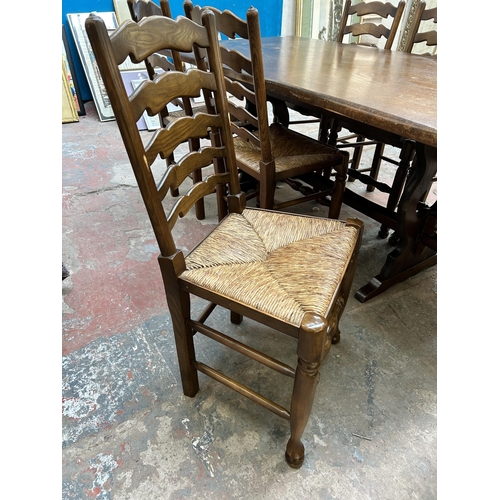 13 - An oak twin pedestal rectangular dining table and six 19th century style elm and beech rush seated L... 