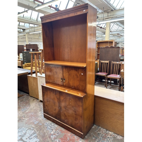 25 - A Georgian style yew wood bookcase