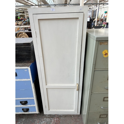 173 - A 1950s white painted single door cabinet
