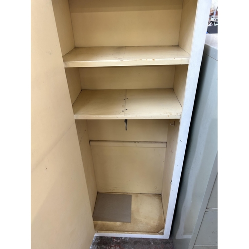 173 - A 1950s white painted single door cabinet