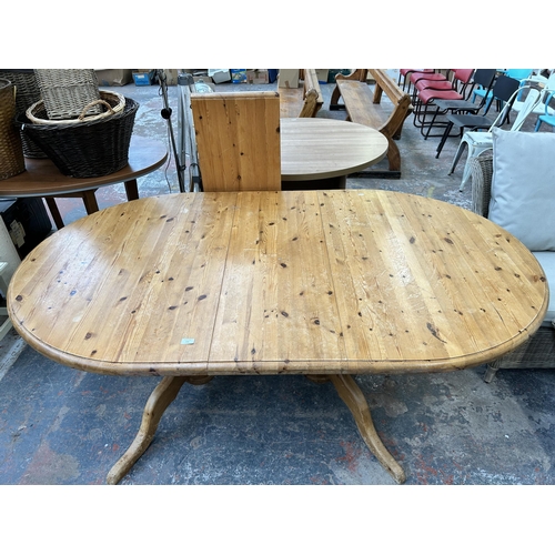 197 - A modern pine oval extending twin pedestal dining table