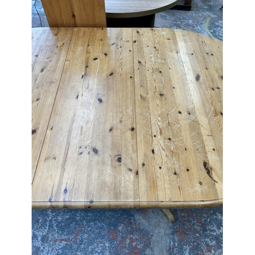 197 - A modern pine oval extending twin pedestal dining table