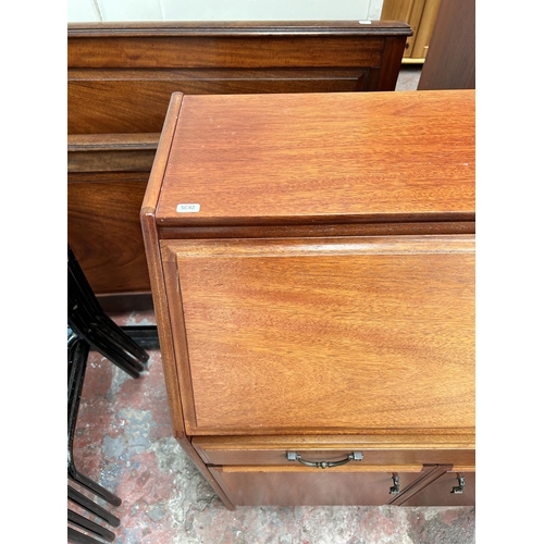 103 - A late 20th century teak bureau with two lower cupboard doors, single drawer and fall front