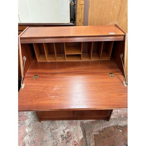 103 - A late 20th century teak bureau with two lower cupboard doors, single drawer and fall front