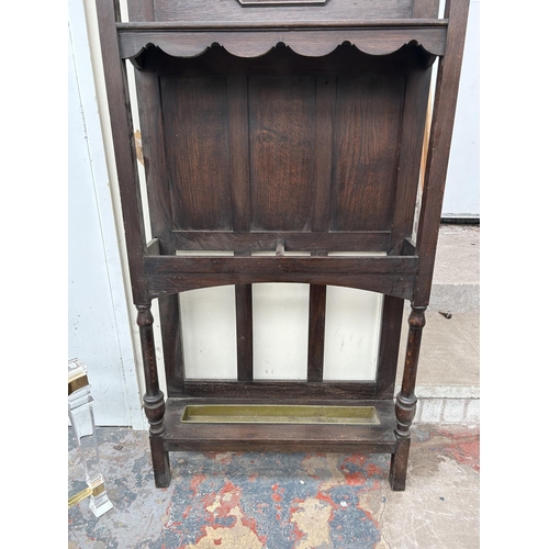 107 - An early 20th century oak hallstand with central octagonal bevelled edge mirror, two section stick s... 