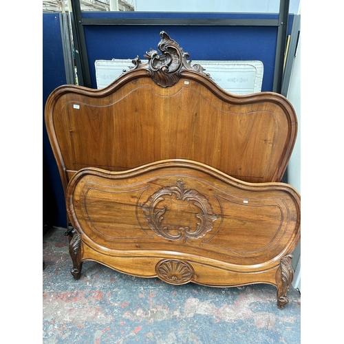 111 - A French carved walnut queen size bedframe