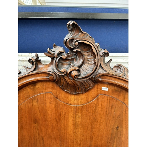 111 - A French carved walnut queen size bedframe