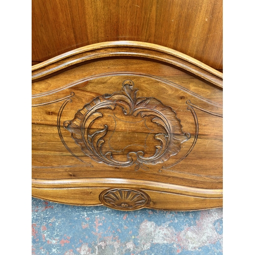 111 - A French carved walnut queen size bedframe