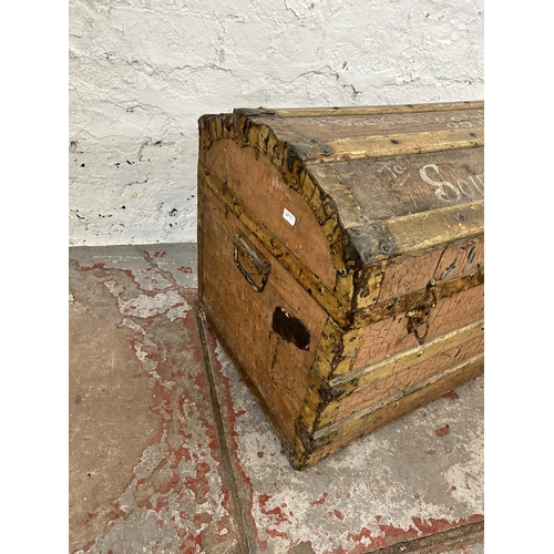 136 - An early 20th century wooden banded and canvas dome top travel trunk stating 'Mrs S. E. Adams passen... 