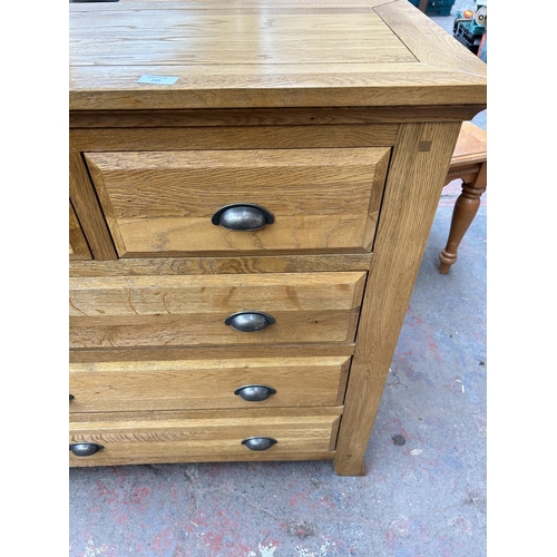 145 - A modern solid oak chest of two short over three long drawers