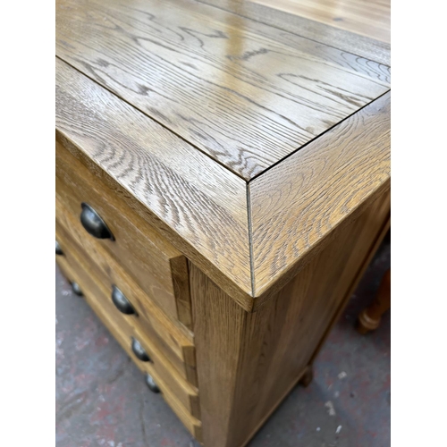 145 - A modern solid oak chest of two short over three long drawers