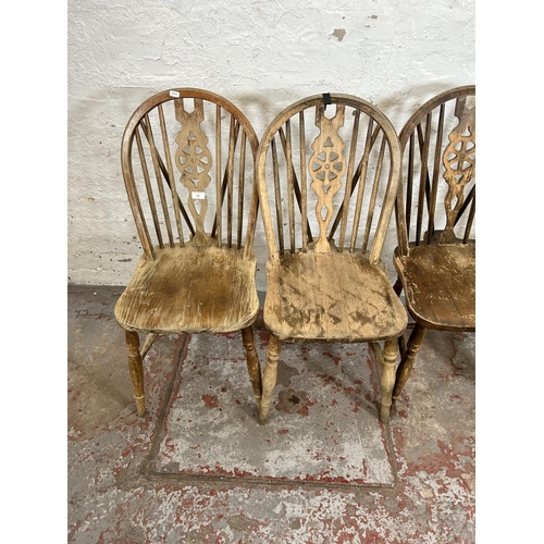 159 - A set of four beech wheelback dining chairs