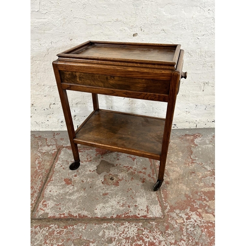 16 - A mid 20th century oak rectangular two tier serving trolley with removable tray and single drawer