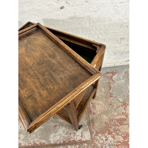 16 - A mid 20th century oak rectangular two tier serving trolley with removable tray and single drawer