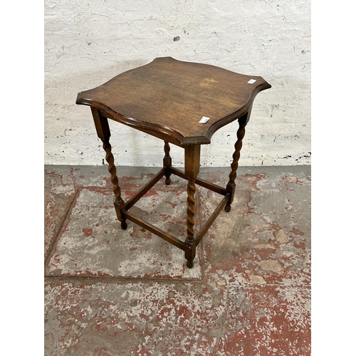 17 - An early 20th century oak serpentine side table on barley twist supports