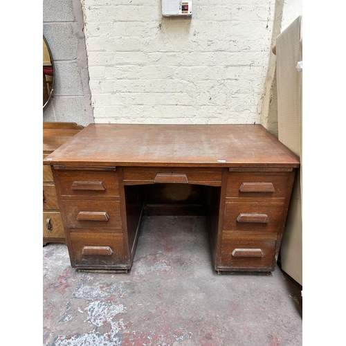 18 - A 1930s mahogany pedestal office desk with seven drawers - approx. 76cm high x 126cm wide x 76cm dee... 