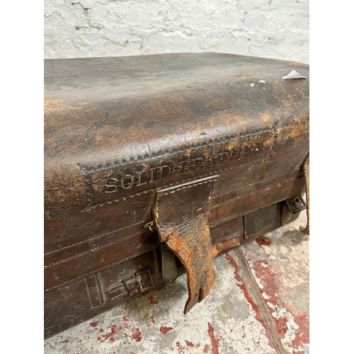 181 - An early 20th century brown leather suitcase monogrammed K. B.