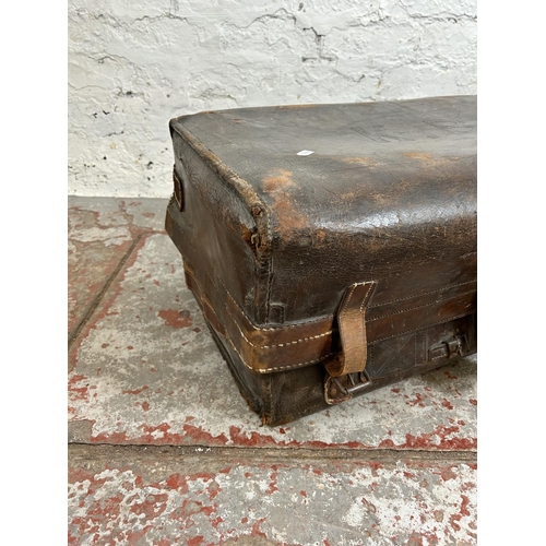 181 - An early 20th century brown leather suitcase monogrammed K. B.