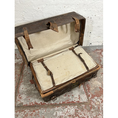 181 - An early 20th century brown leather suitcase monogrammed K. B.