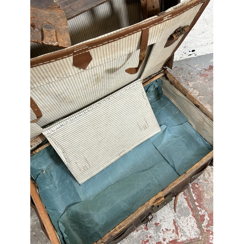 181 - An early 20th century brown leather suitcase monogrammed K. B.