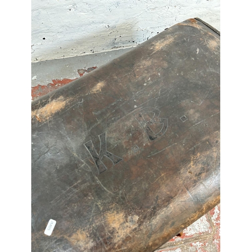 181 - An early 20th century brown leather suitcase monogrammed K. B.